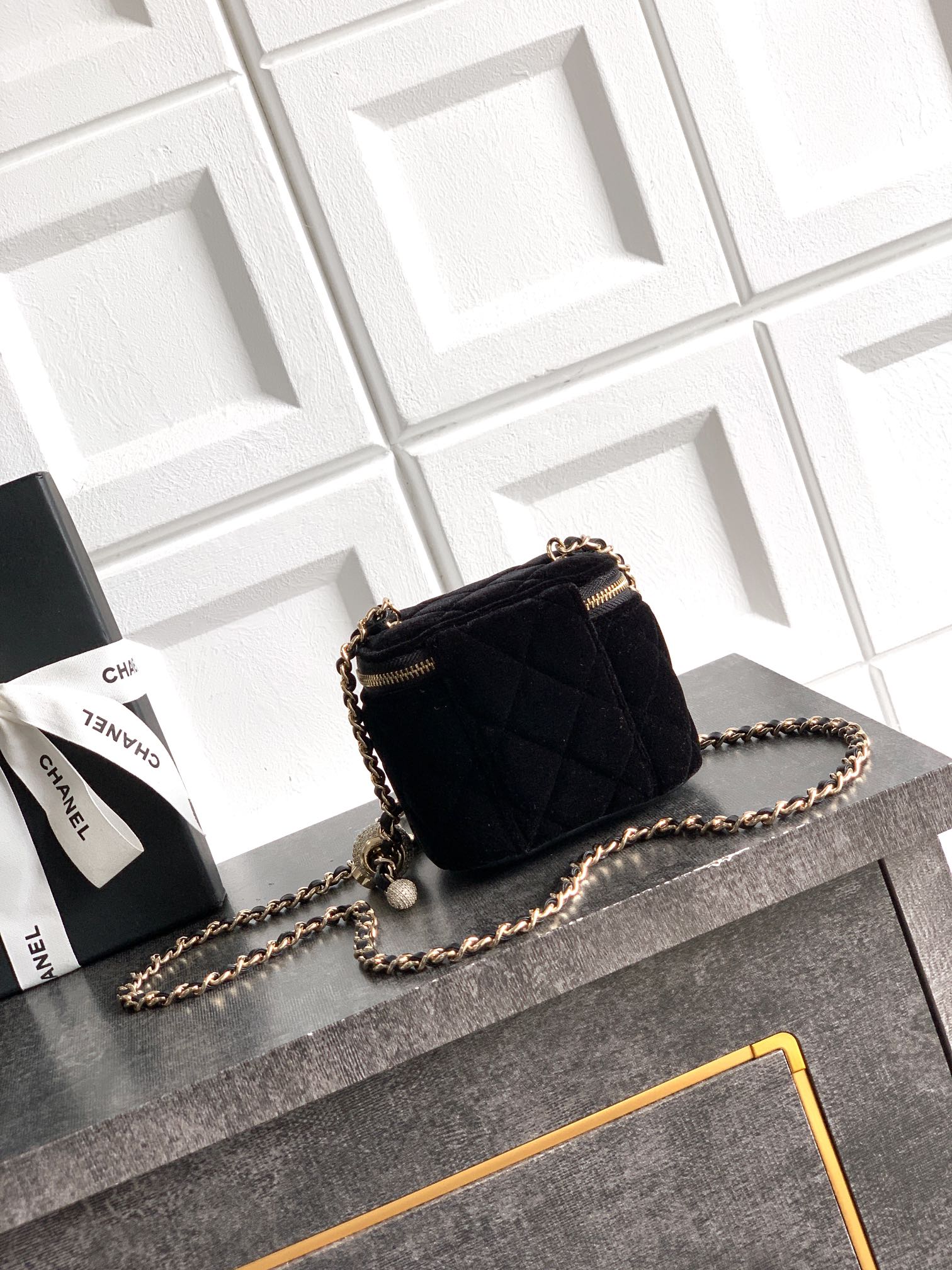 Black Chanel quilted mini crossbody bag with gold zipper and chain strap