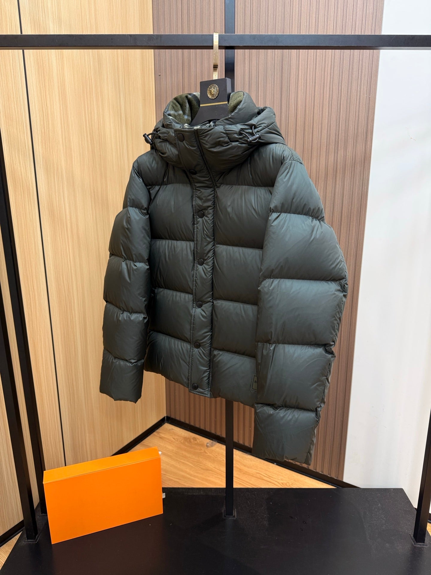 Burberry dark green hooded puffer jacket, quilted design, angled side view