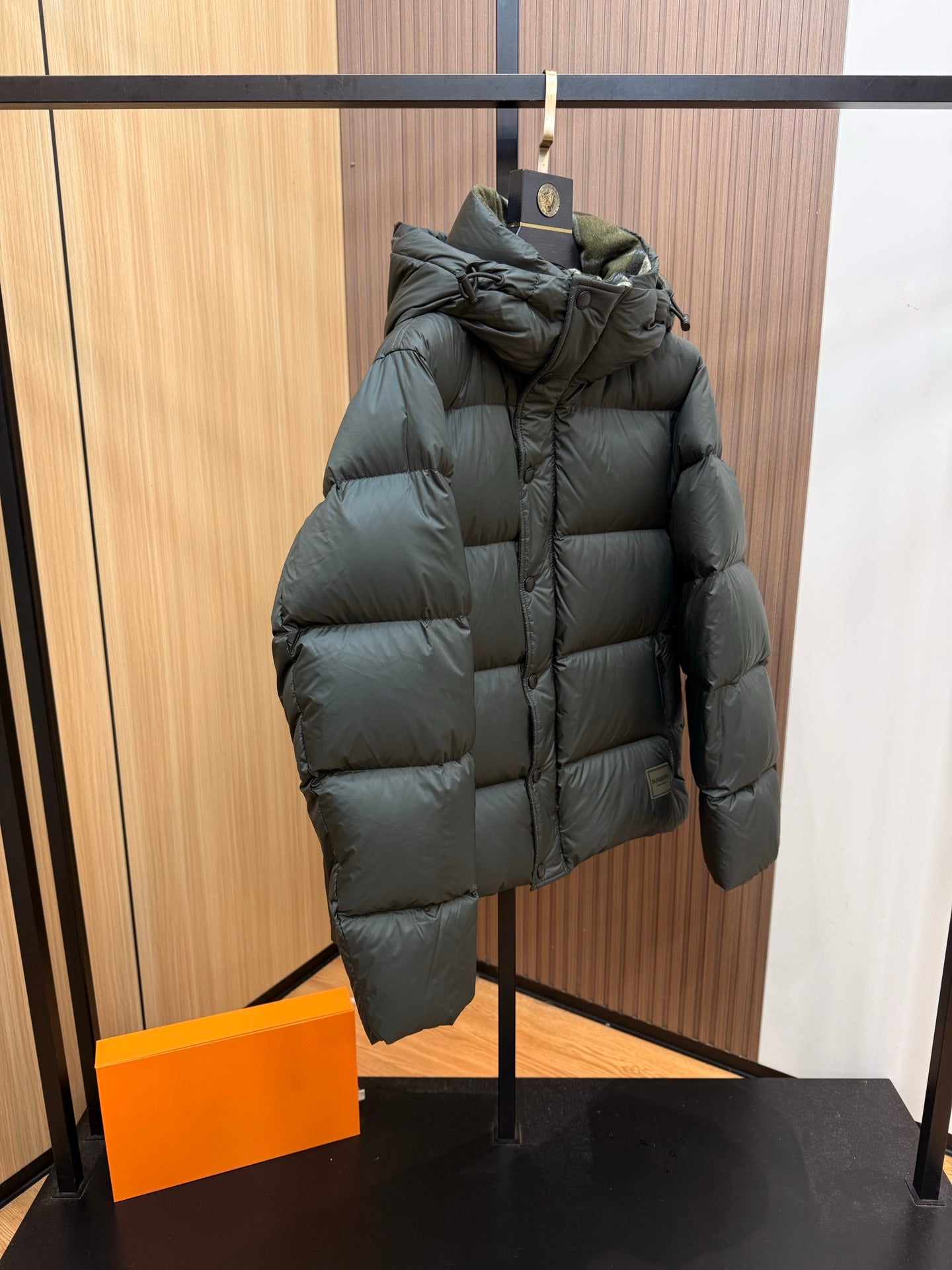 Burberry dark green hooded puffer jacket, quilted silhouette, sleeve and front panel view