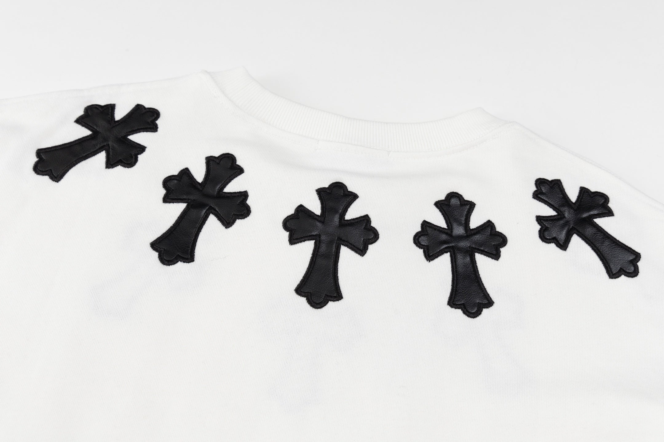 White crewneck sweatshirt with multiple black cross appliques