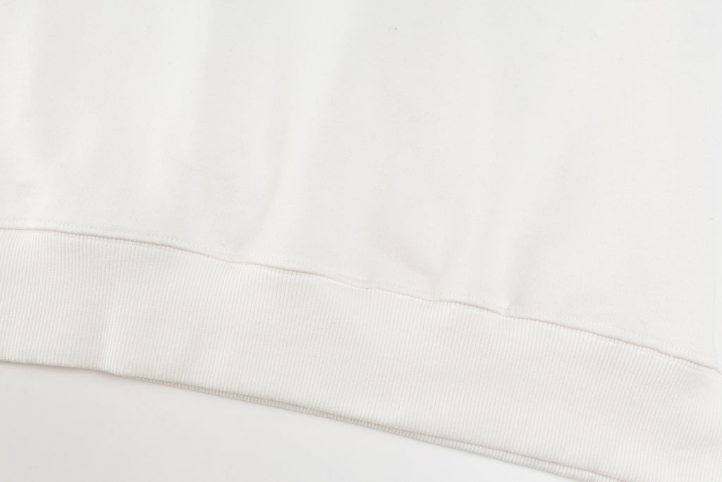 White crewneck sweatshirt hem with ribbed waistband