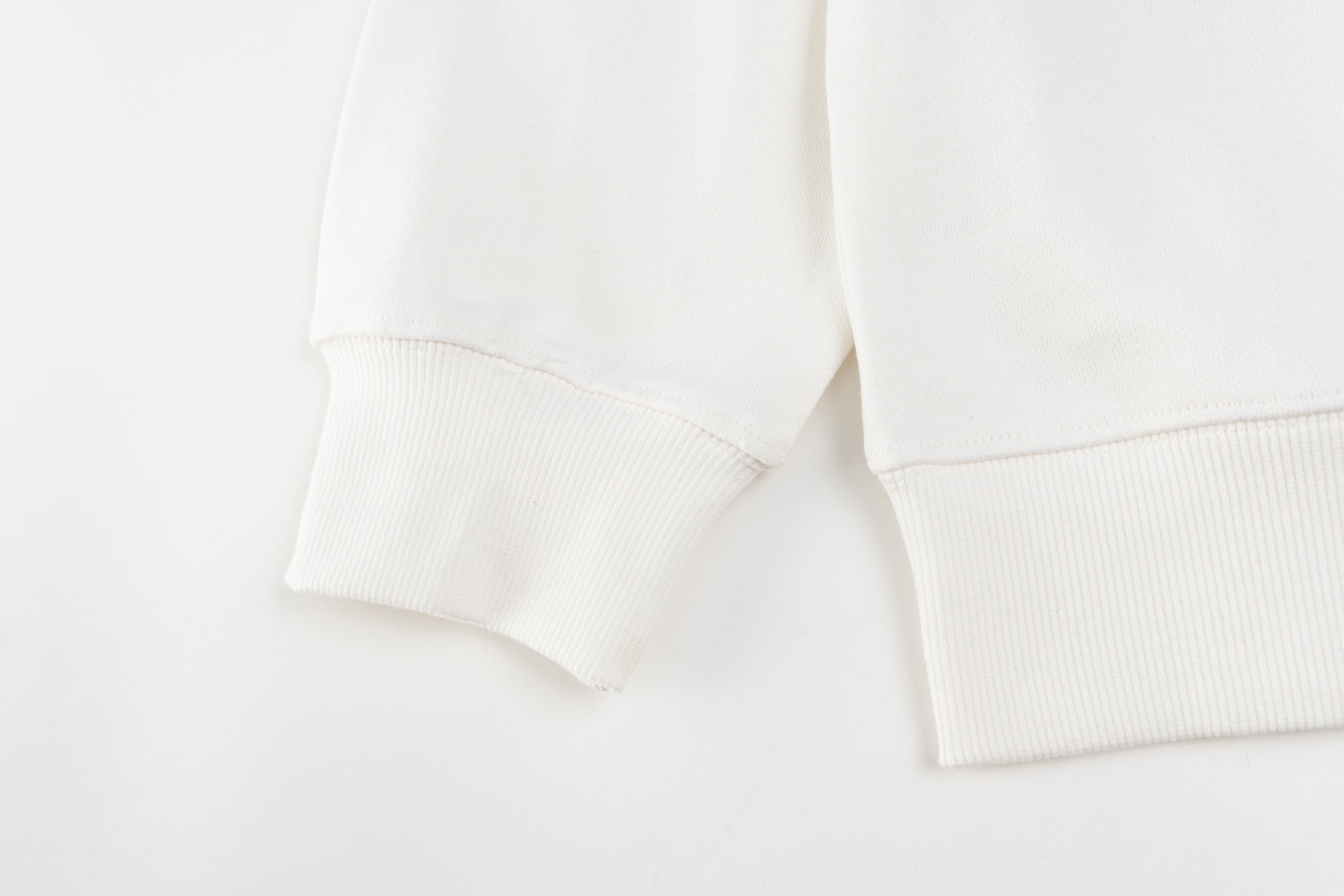 White crewneck sweatshirt sleeves with ribbed cuffs
