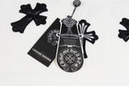 White crewneck sweatshirt detail: black cross pendant graphic and label