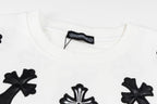 White crewneck sweatshirt neckline with black cross patch and brand label