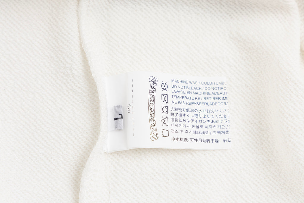 White long-sleeve garment care label on inner neck