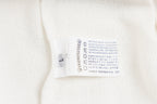 White long-sleeve garment care label on inner neck