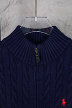 Navy knit quarter-zip sweater close-up with ribbed collar and zipper pull