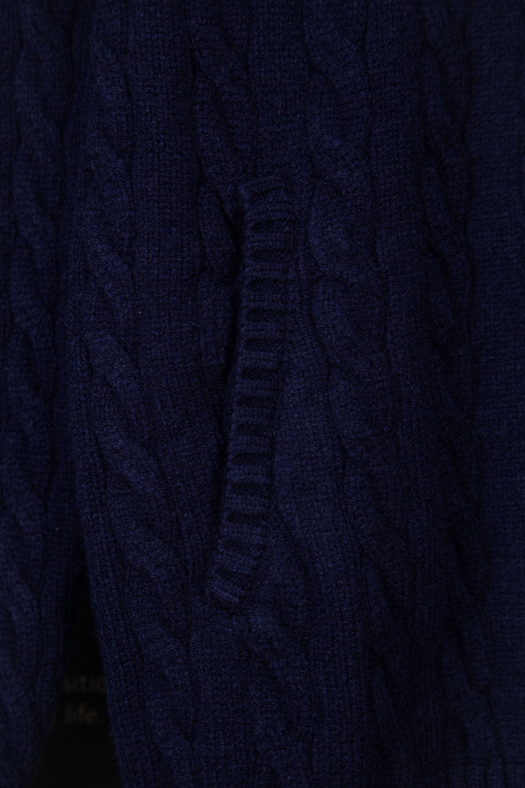 Navy knit quarter-zip sweater front seam and zipper placket detail