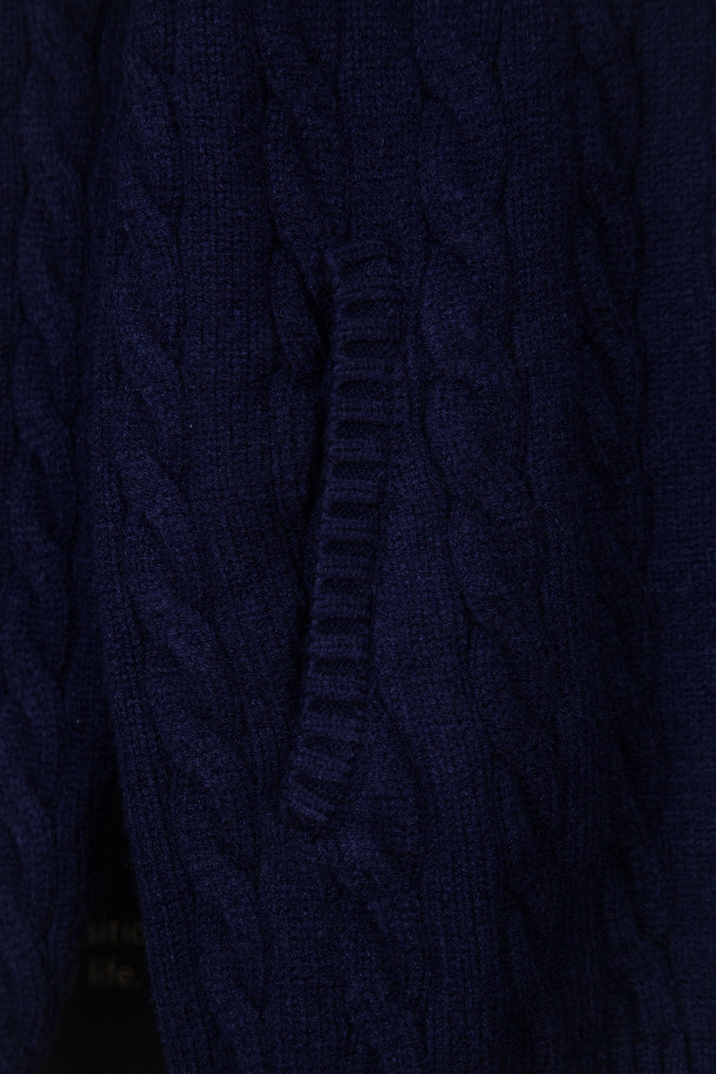 Navy knit quarter-zip sweater front seam and zipper placket detail