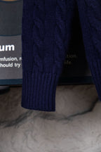 Navy knit sweater sleeve cuff with ribbed knit detail