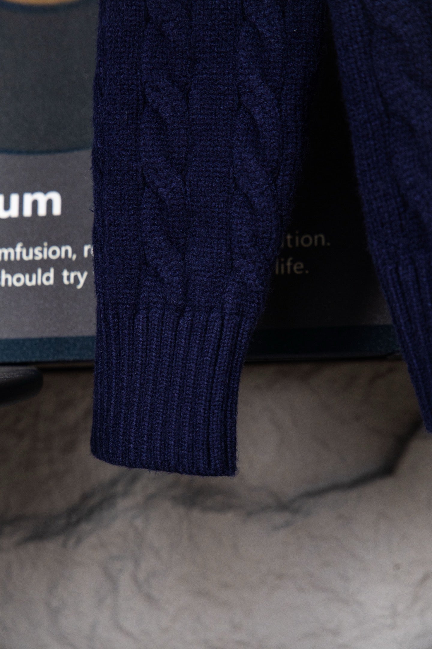 Navy knit sweater sleeve cuff with ribbed knit detail