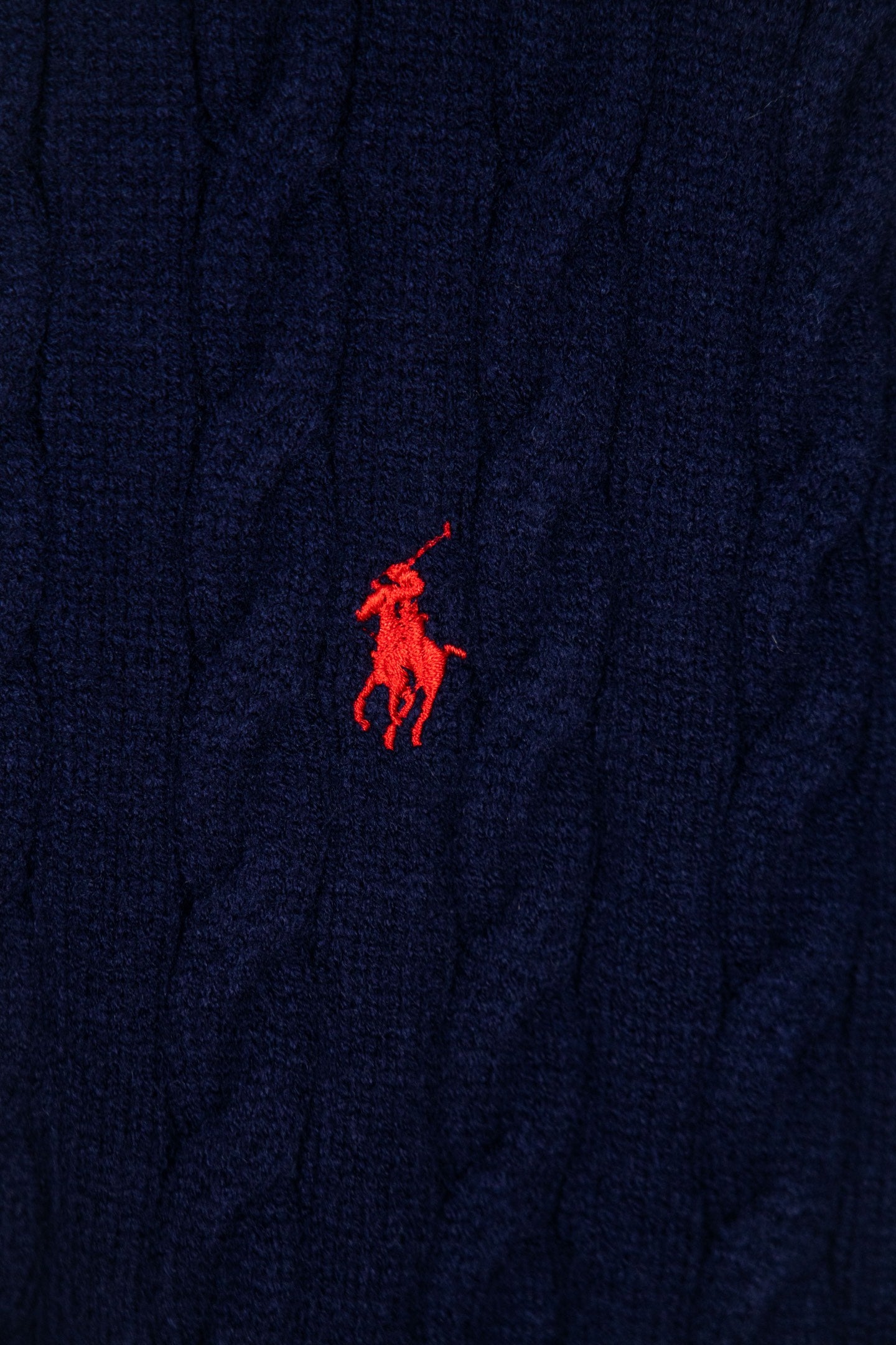 Navy knit sweater with small red Polo pony logo at chest