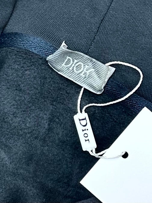Dark blue hoodie with inner neck label reading Dior and size tag