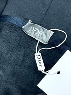 Dark blue hoodie with inner neck label reading Dior and size tag