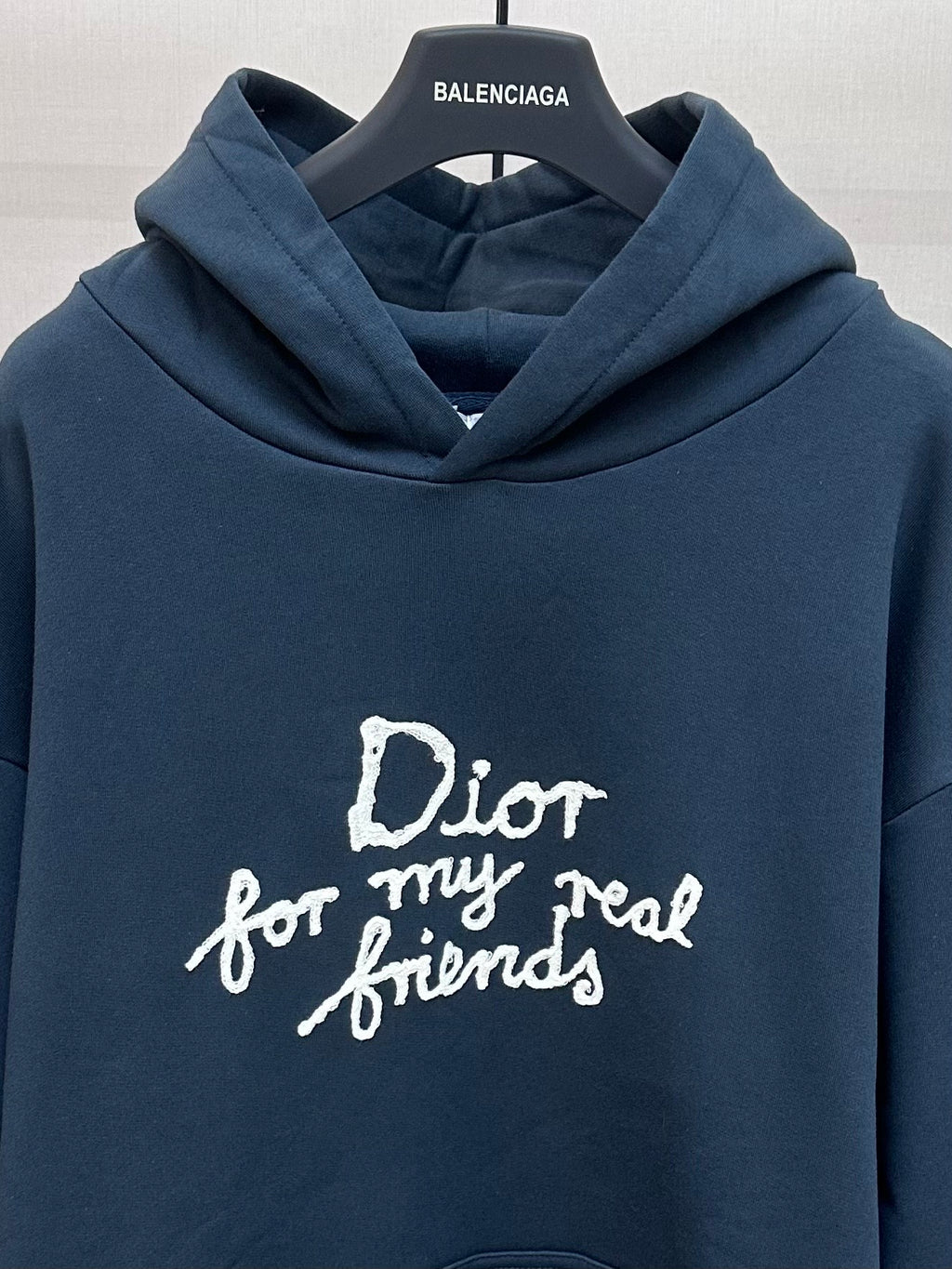 Dark blue hoodie with large white 'Dior for my real friends' lettering on chest