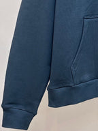 Dark blue hoodie with kangaroo pocket and ribbed cuffs; partial logo print