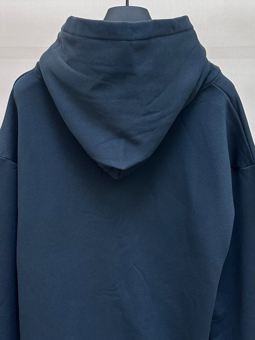 Dark blue hoodie back view with hood and no visible graphics