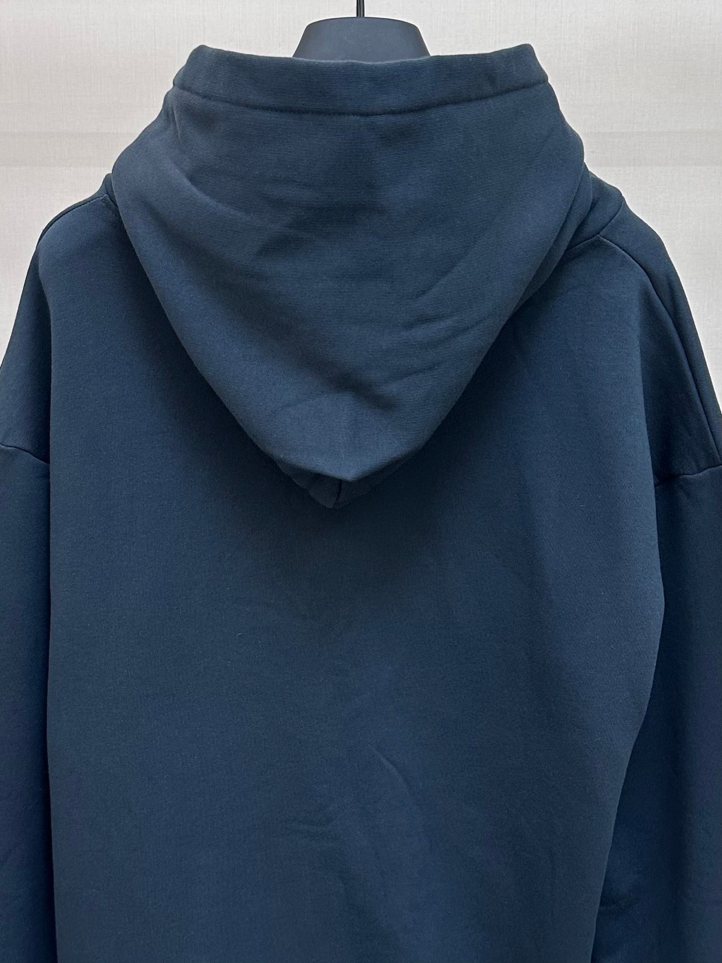 Dark blue hoodie back view with hood and no visible graphics