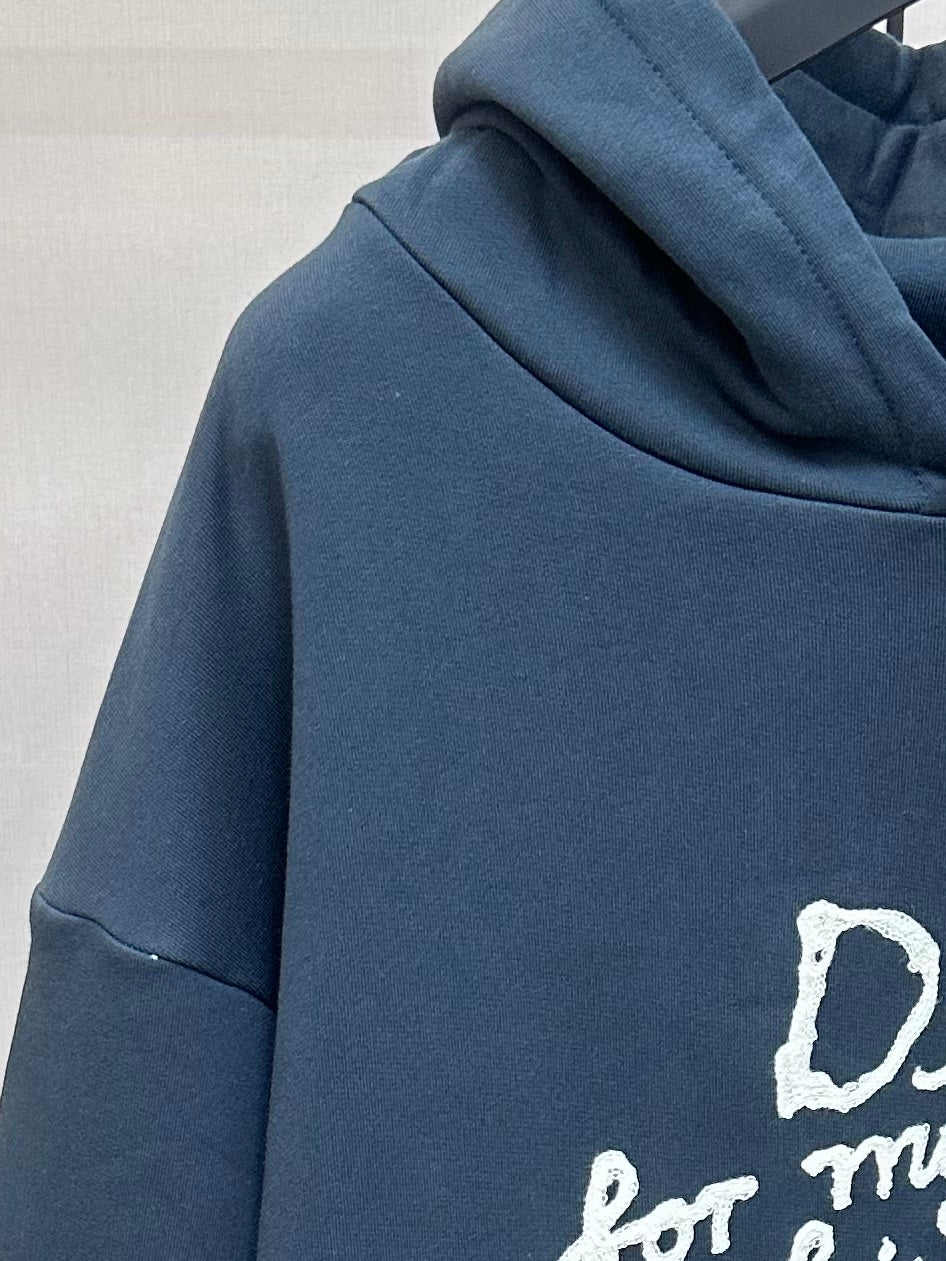 Dark blue hoodie sleeve with partial white 'Dior for my real friends' print