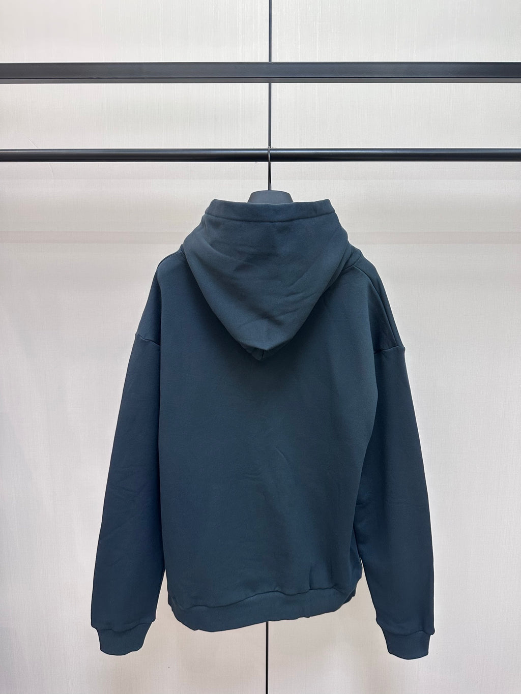 Dark blue hoodie with hood and kangaroo pocket, back view