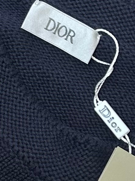 Dior clothing tag and Dior neck label tied on navy knit sweater