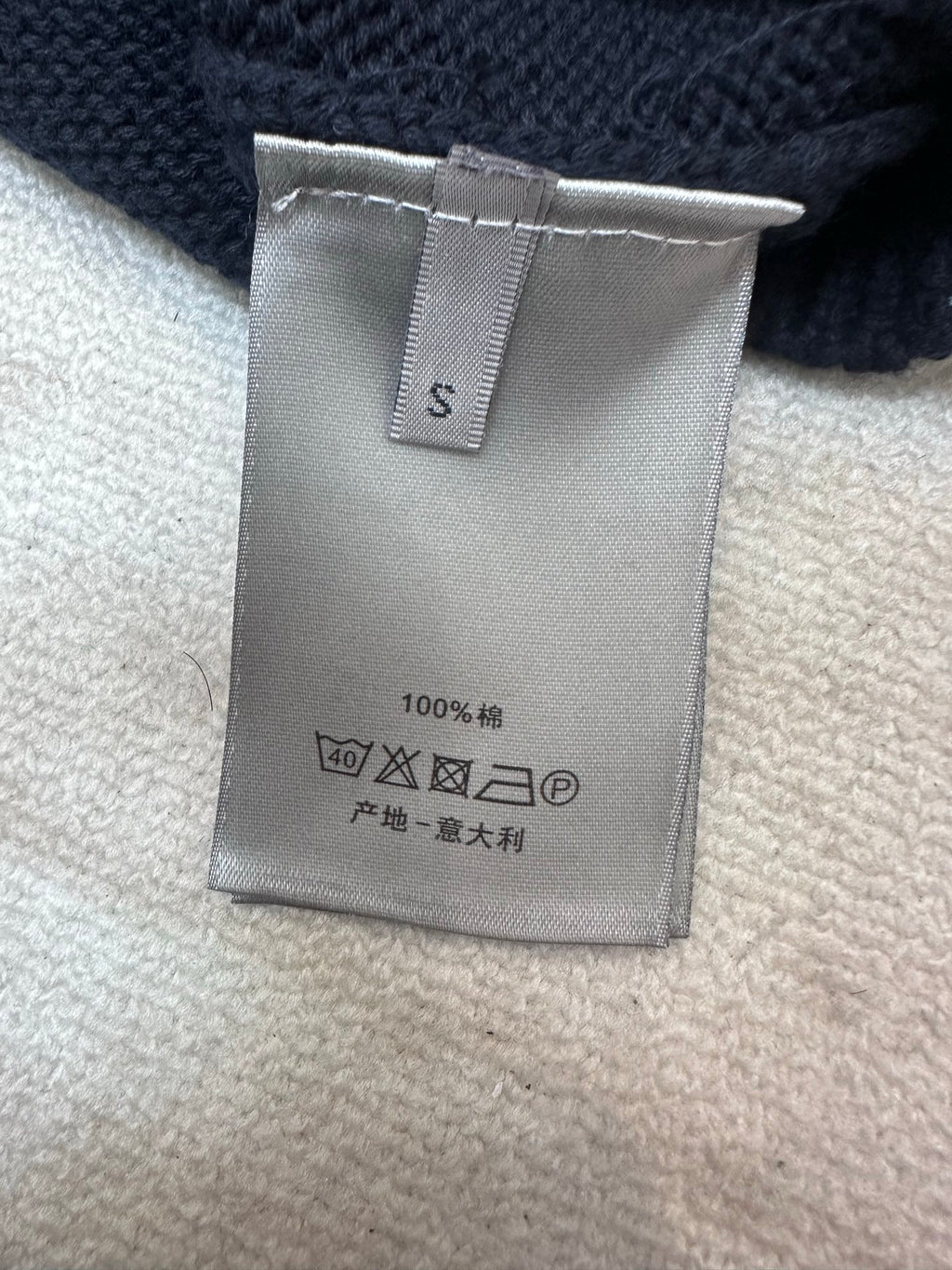 Dior size tag with care symbols on navy knit sweater, 100% wool