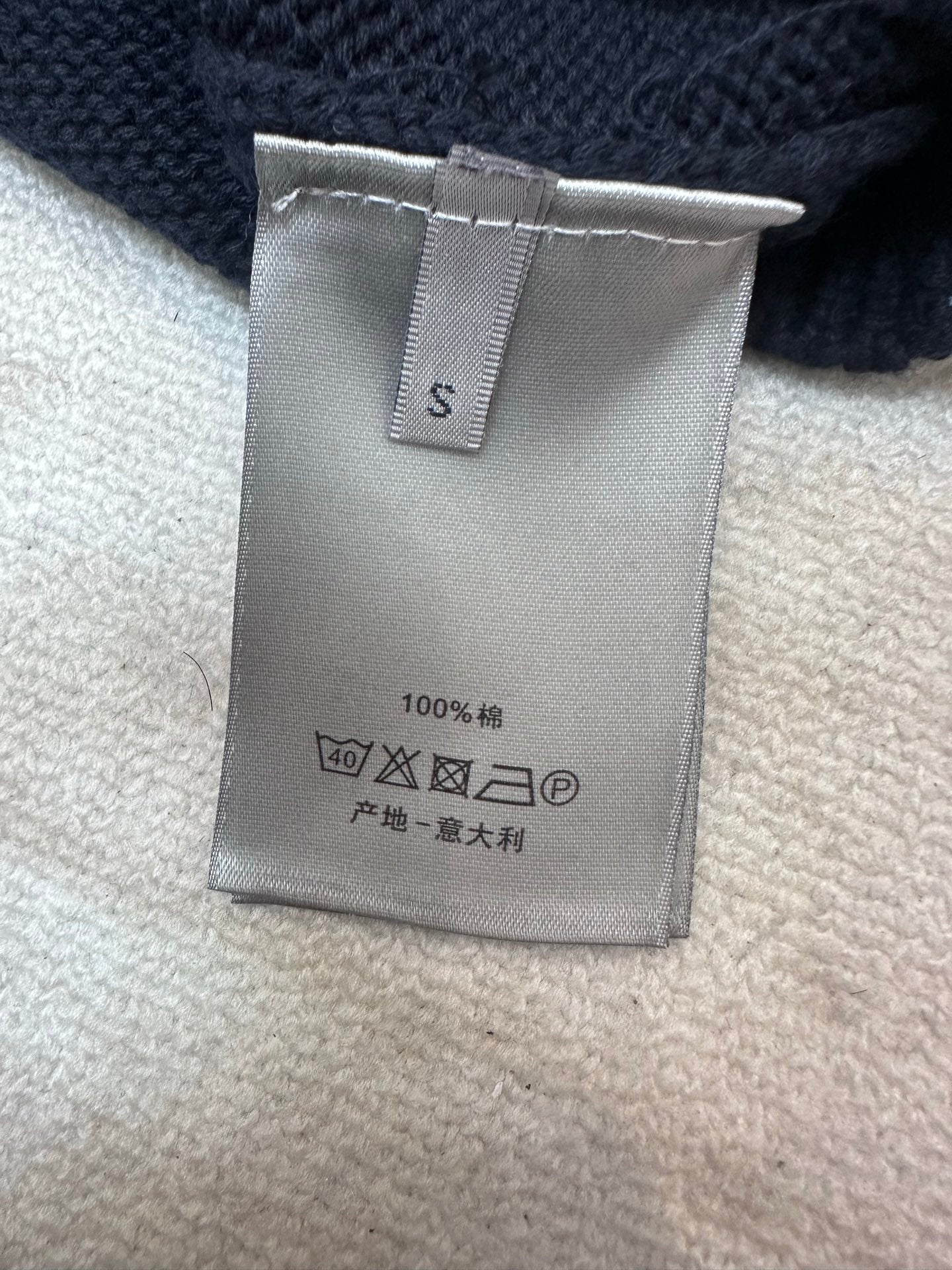 Dior size tag with care symbols on navy knit sweater, 100% wool