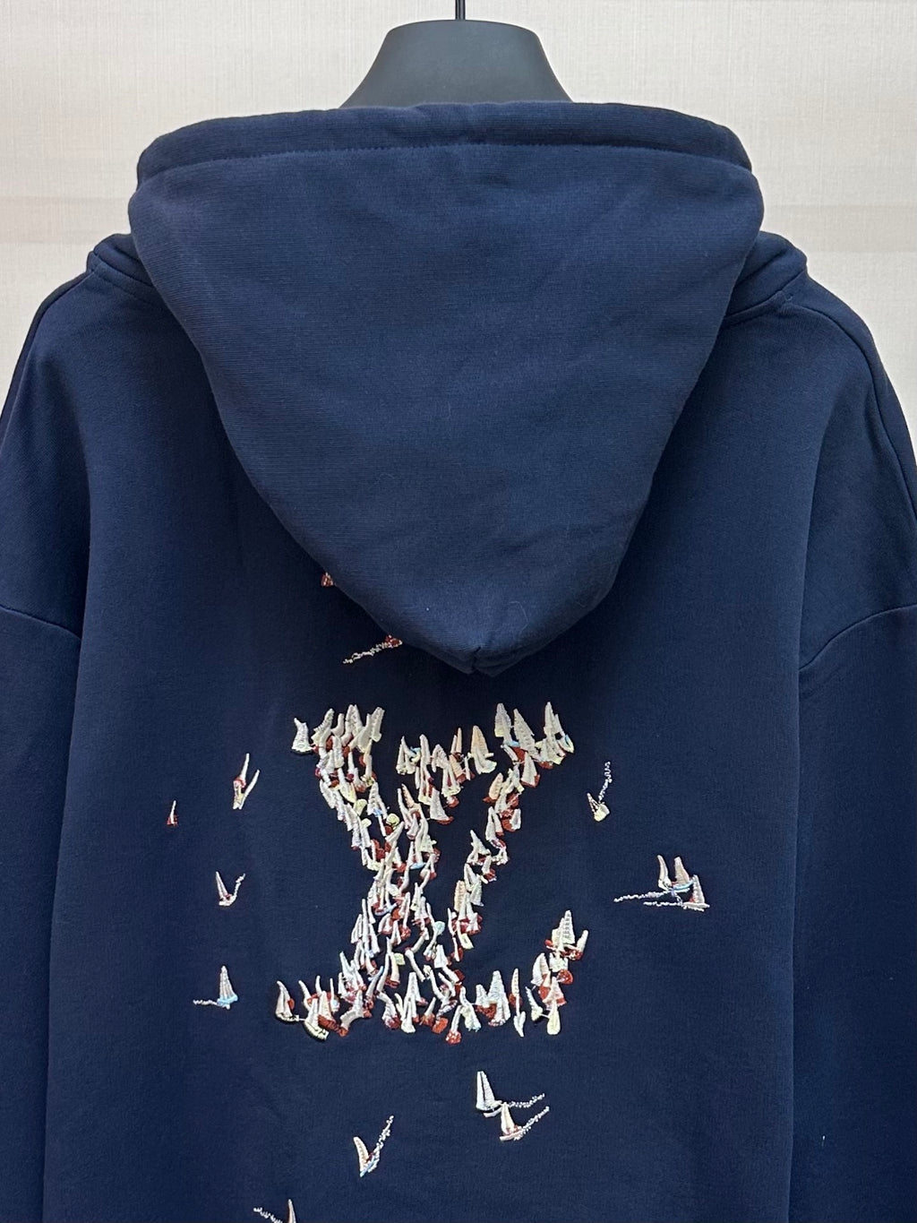Navy hoodie with hood and large back print of sailboats and figures