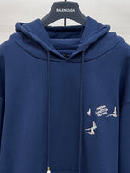 Navy hoodie with hood and drawstrings, chest graphic with sailboats
