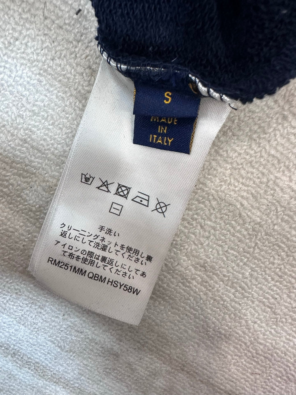 Hoodie care label showing size S and Made in Italy