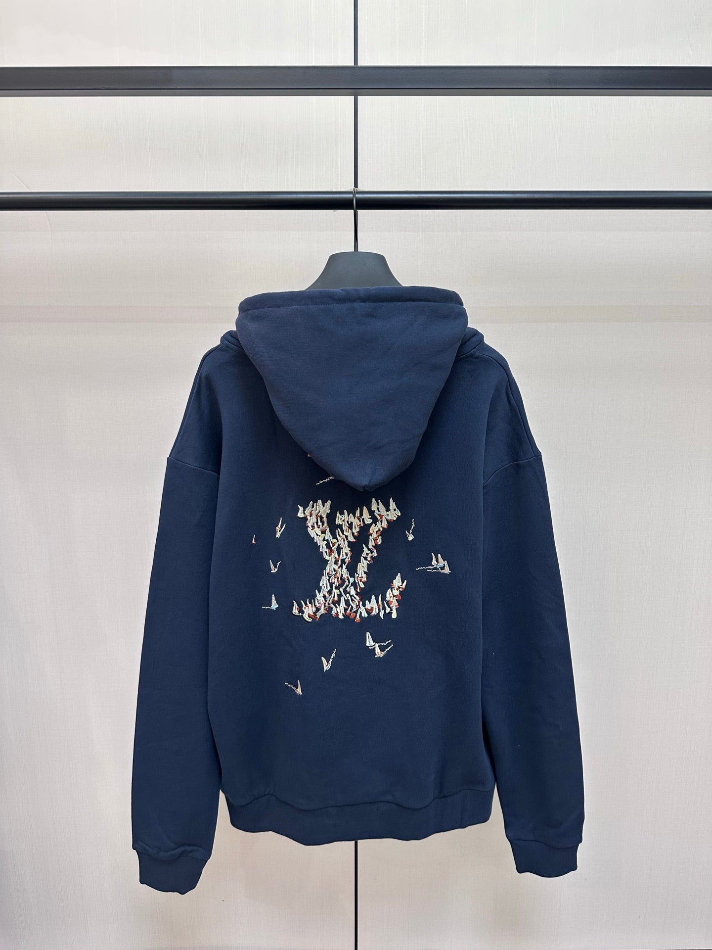 Navy hoodie with hood and large back graphic of sailboats and figures