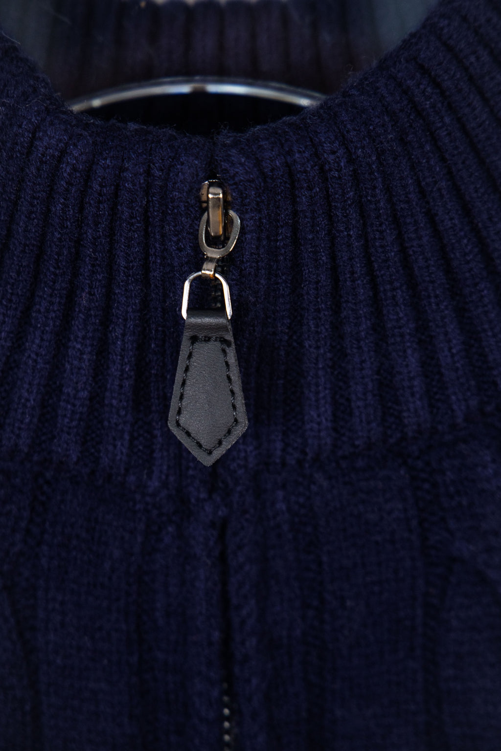 Navy quarter-zip sweater zipper with gray leather pull tab