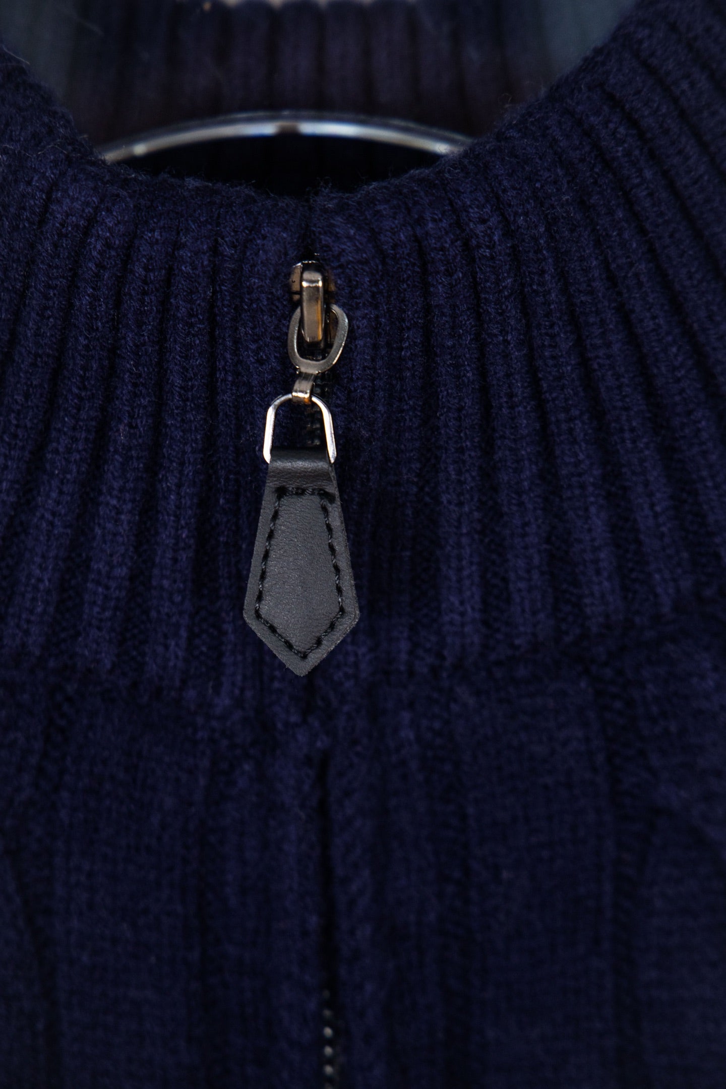 Navy quarter-zip sweater zipper with gray leather pull tab