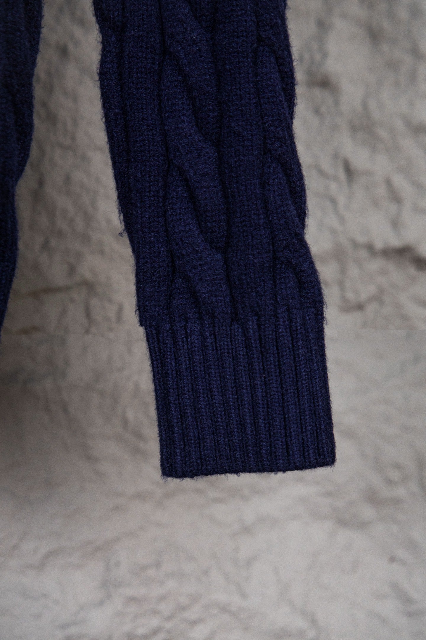 Navy cable-knit sweater hem with ribbed trim