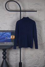 Navy cable-knit quarter-zip sweater on hanger with high ribbed collar