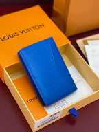 Blue Louis Vuitton card holder with textured pattern and foldover flap, front view.