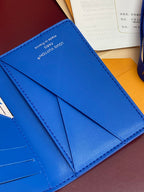 Blue Louis Vuitton card holder interior with multiple card slots and seam stitching.
