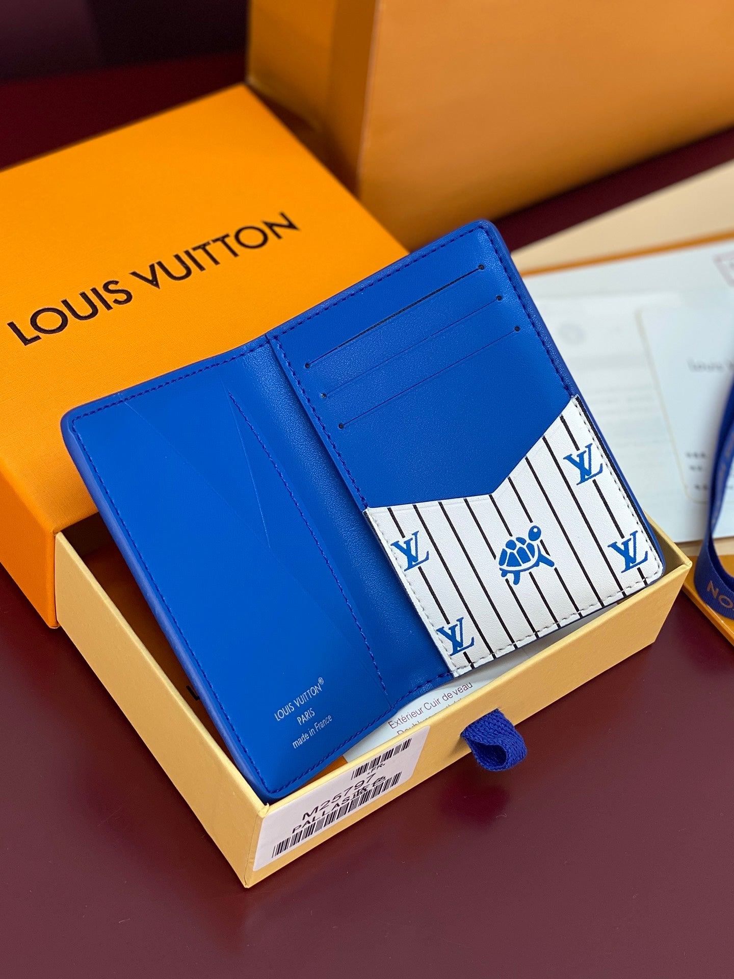 Blue Louis Vuitton small bag opened flat, interior lining with signature pattern