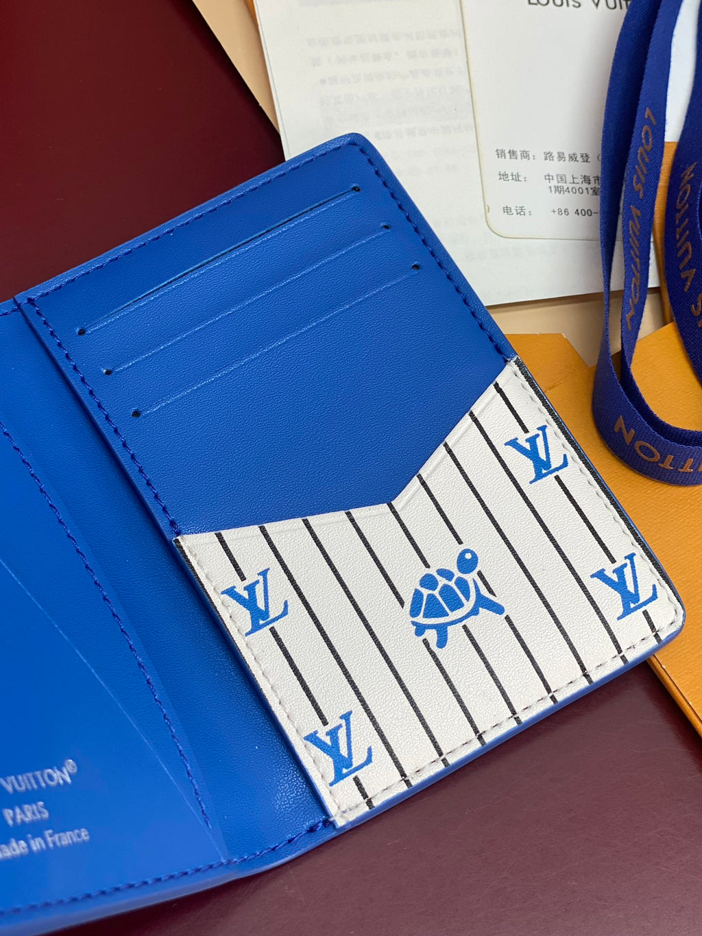 Blue Louis Vuitton small bag interior showing striped lining and card slot stitching