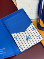 Blue Louis Vuitton small bag interior showing striped lining and card slot stitching