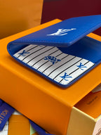 Louis Vuitton small bag, blue leather with LV logo and striped interior.