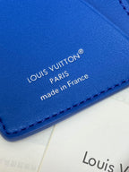 Blue Louis Vuitton card holder label with 'made in France' text and stitched edge.