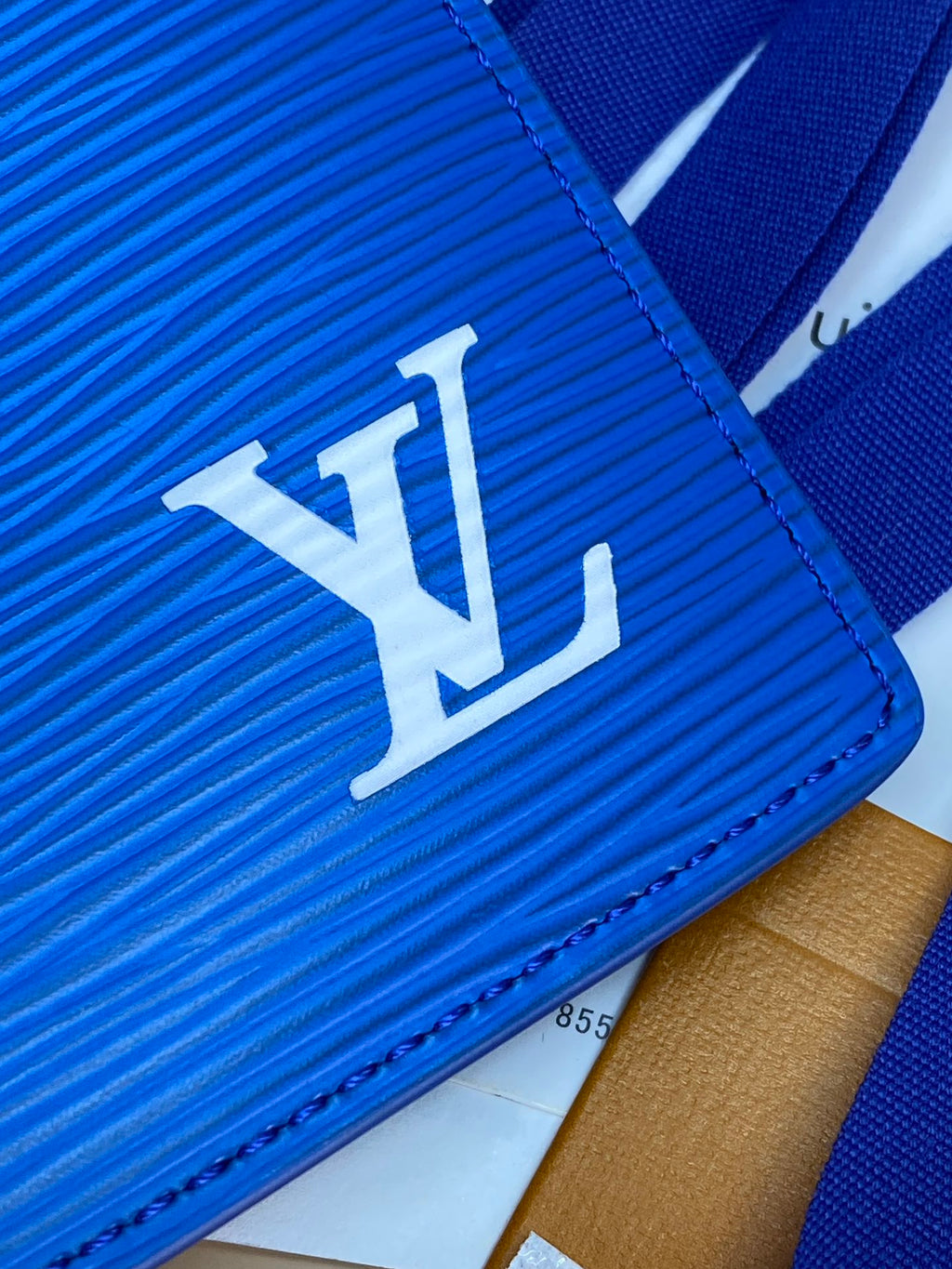 Blue Louis Vuitton small bag close-up with LV logo on textured leather