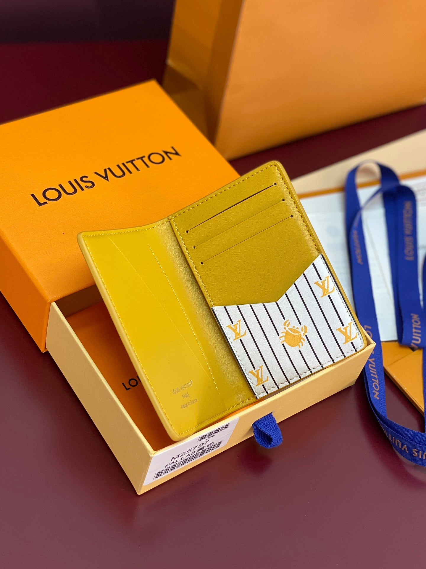 Yellow leather card holder open, striped lining with LV and bee motif