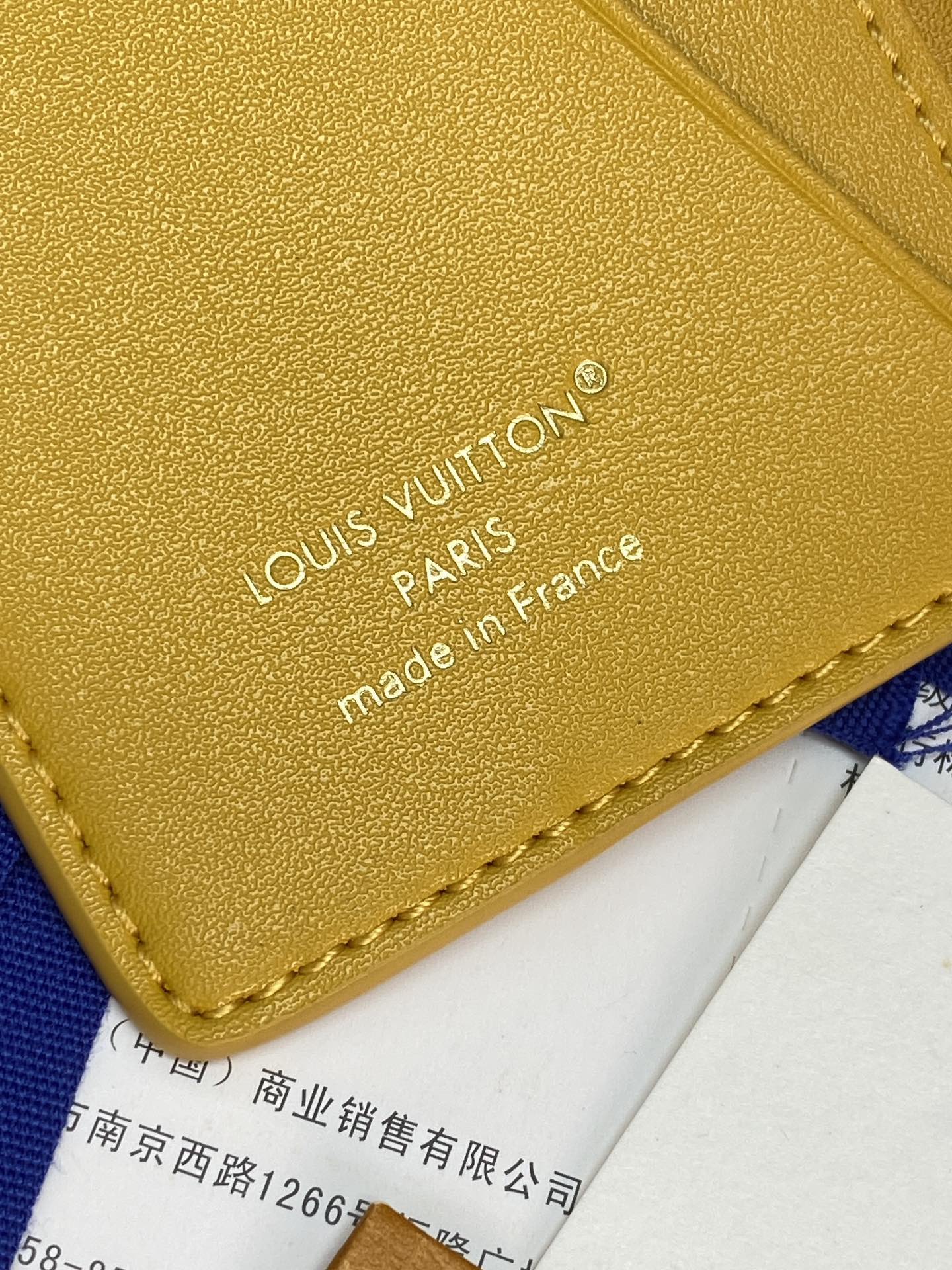 Yellow leather card holder back with embossed Louis Vuitton Paris made in France