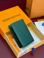 Louis Vuitton teal-green leather card holder with LV logo detail