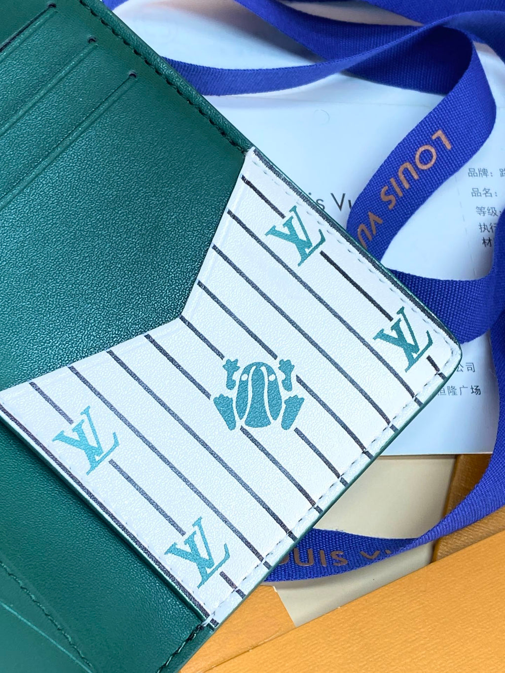 Louis Vuitton small bag wallet, teal green edge with patterned lining and blue ribbon