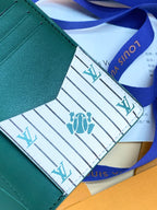 Louis Vuitton small bag wallet, teal green edge with patterned lining and blue ribbon