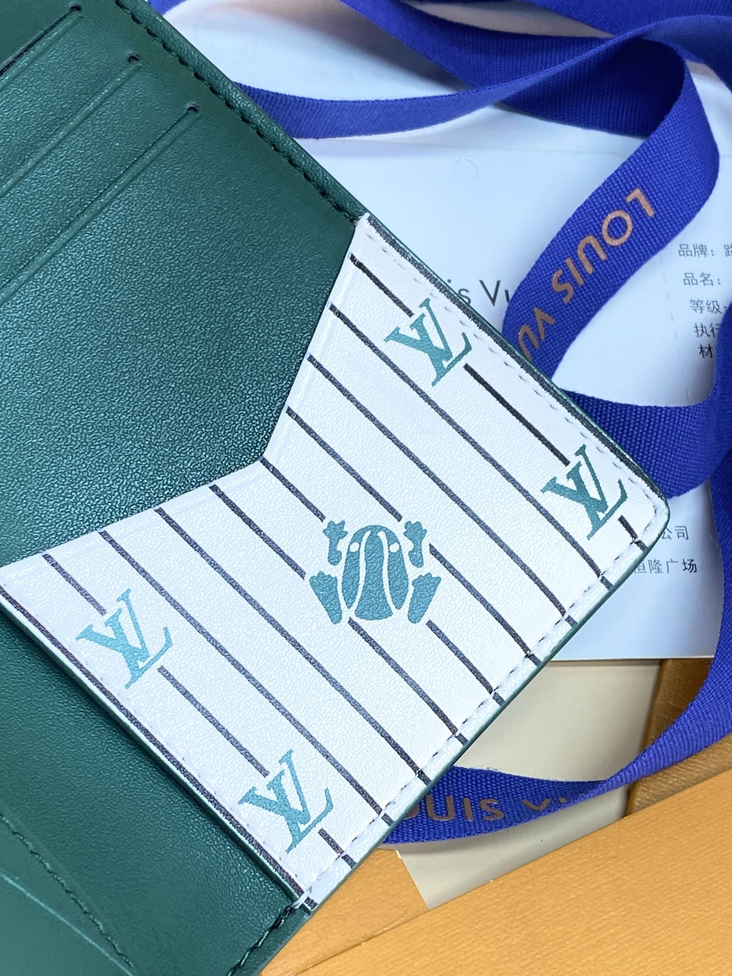 Louis Vuitton small bag wallet, teal green edge with patterned lining and blue ribbon
