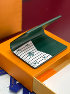 Louis Vuitton small bag wallet, teal green, open interior with card slots and LV pattern